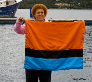 Eve of s/y 'Eve' holding the Chagossian flag which she made