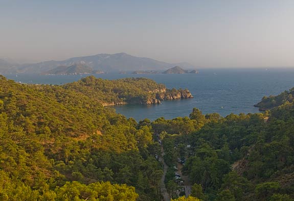 The late afternoon sun lights up the northern side of Fethiye Bay with Delikliadalar Island in the middle distance and Fethiye town in the background