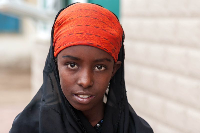 An ethiopian refugee in Massawa in black and orange