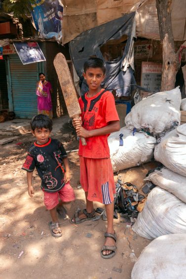 Boy with cricket bat in Dharavi