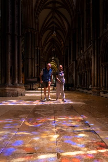 Afternoon light falls through the south-facing stained glass of Lincoln Cathedral
