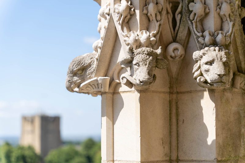 Refurbished stone carvings with the castle in the background